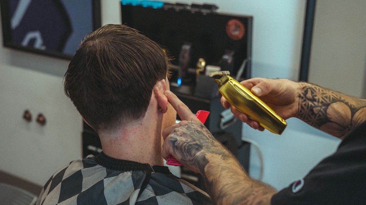 Gold clippers tidying the neckline on a textured crop