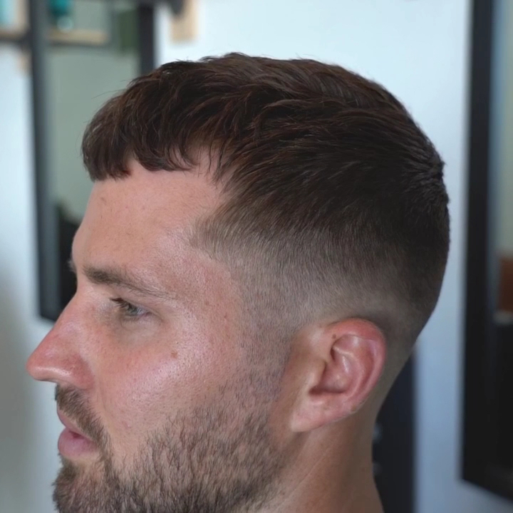 A finished textured crop with a skin fade, side profile